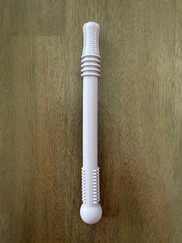 A long white stick teether with ridged ends