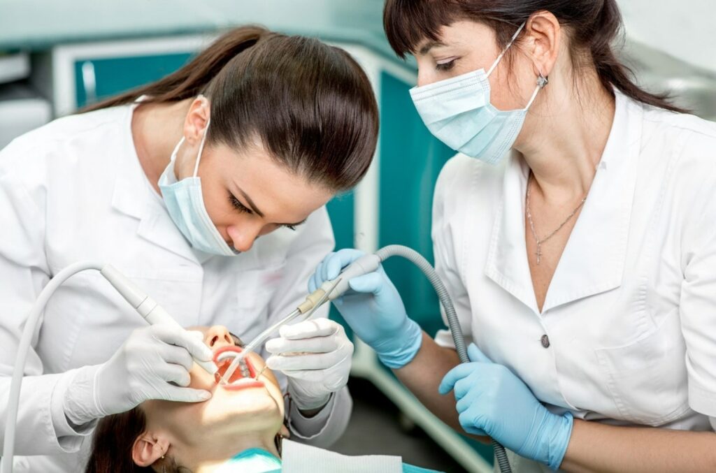 dentist-and-nurse-making-professional-teeth-cleaning-female-young-patient