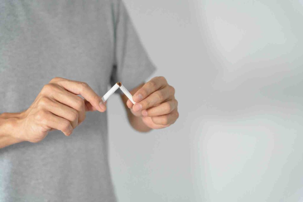 Man destroying cigarette.