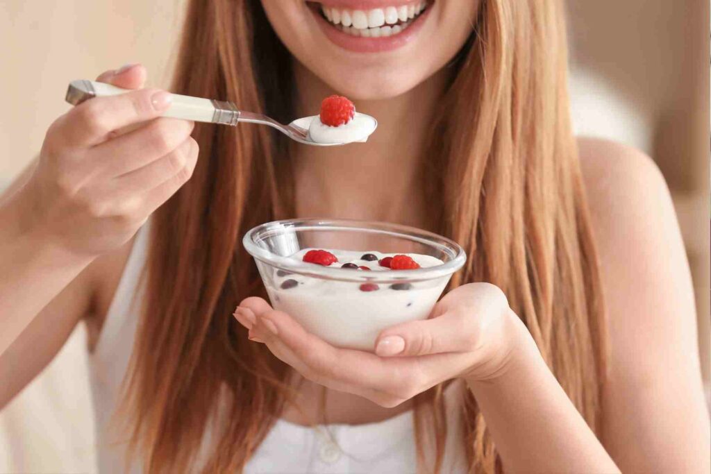 Young Woman Eating Yogurt