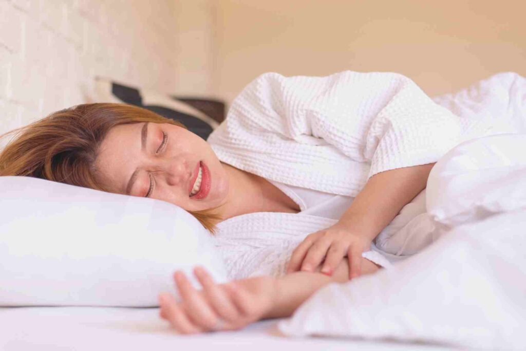 Woman sleeping on the bed and grinding teeth.