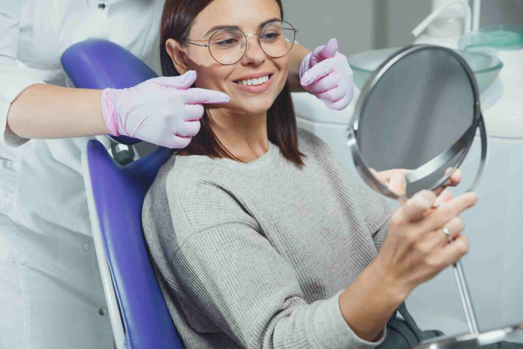 Woman at the dentist looking at her beautiful teeth.