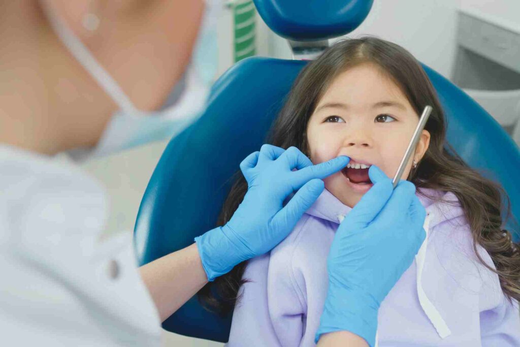 Dentist Checking Teeth of Girl Patient