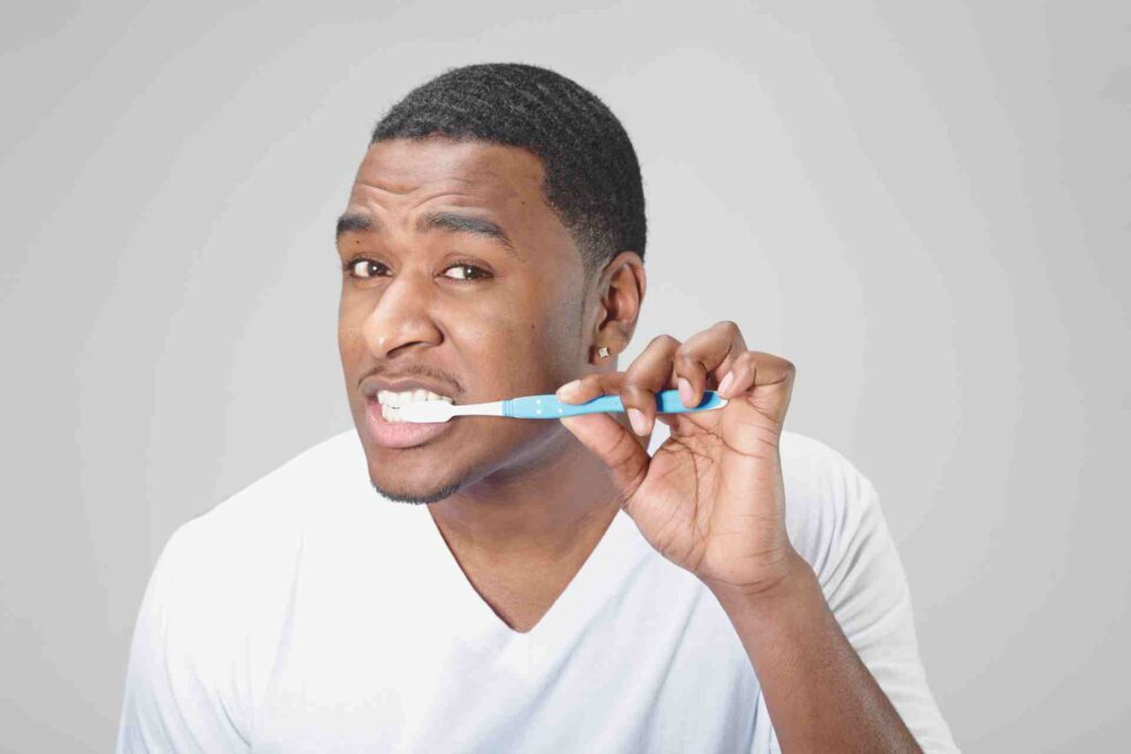 Man brushing his teeth.