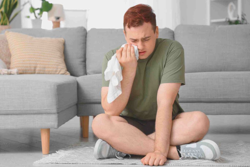 Young Man with Cold Compress