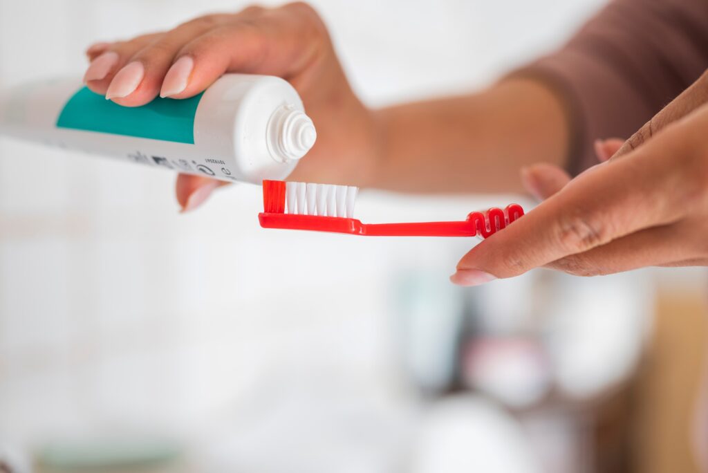 a girl in the bathroom with toothpaste and a brush in her hands for clean teeth