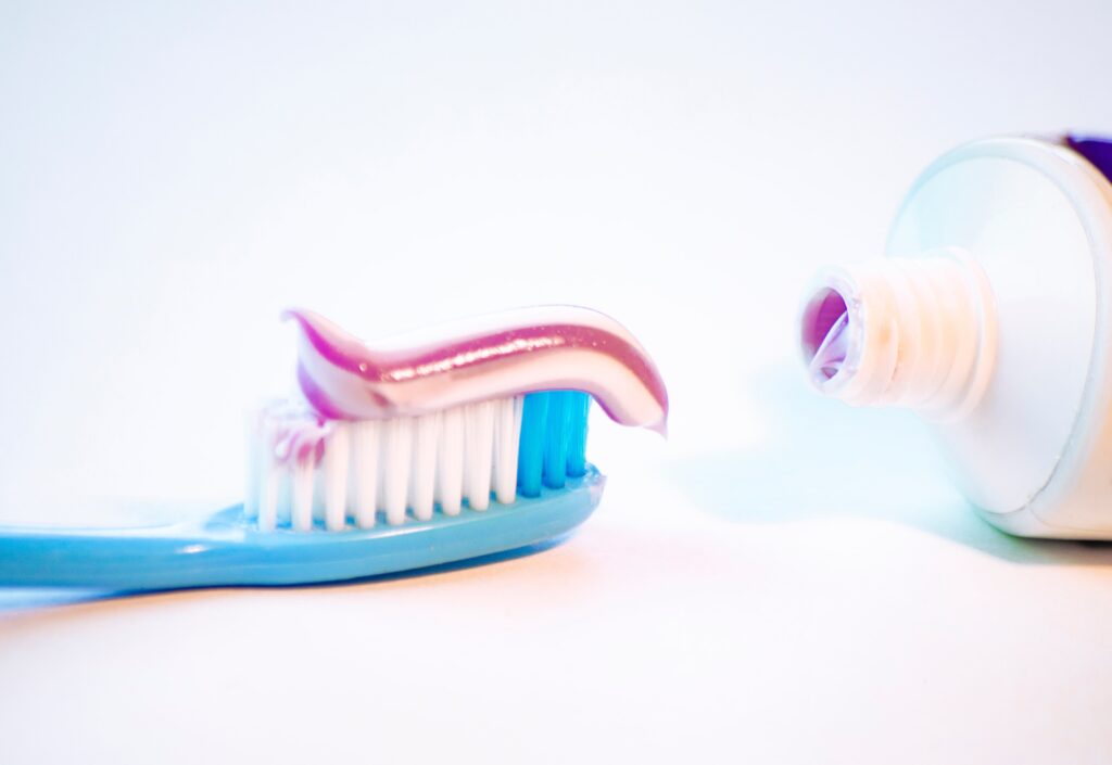 toothbrush for cleaning teeth with toothpaste on a white background