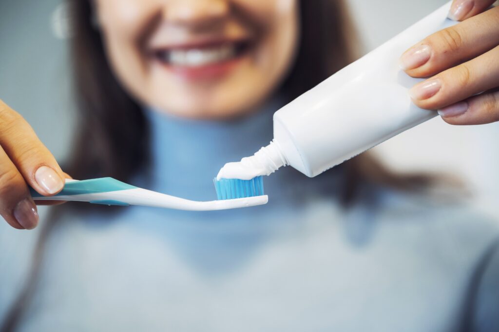 Woman squeezing toothpaste onto her toothbrush