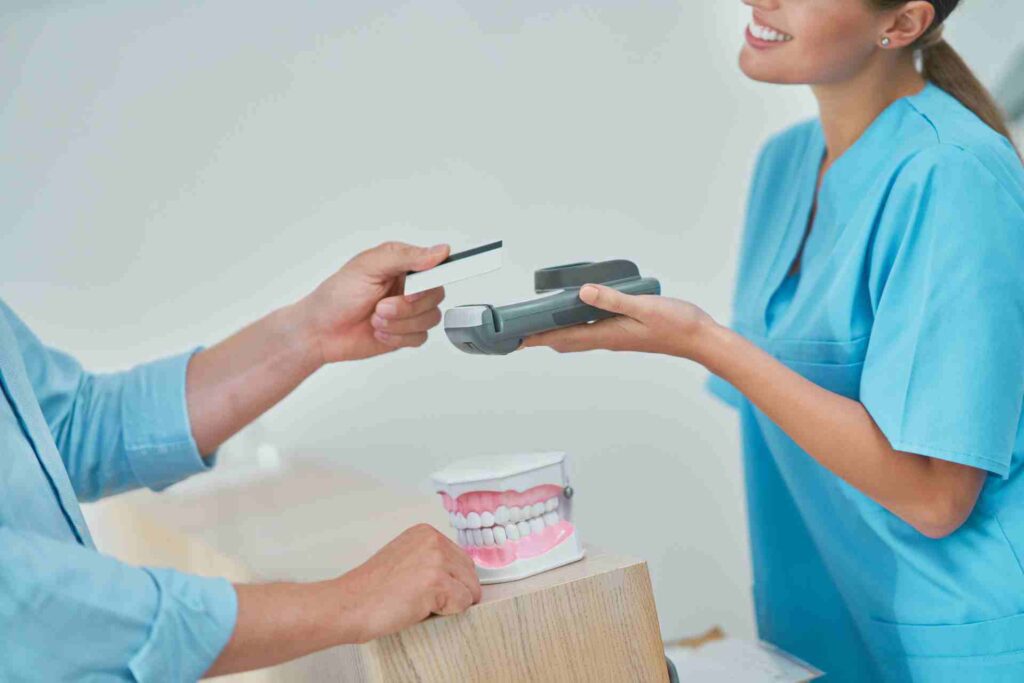 Patient Paying for Dental Visit in Clinic