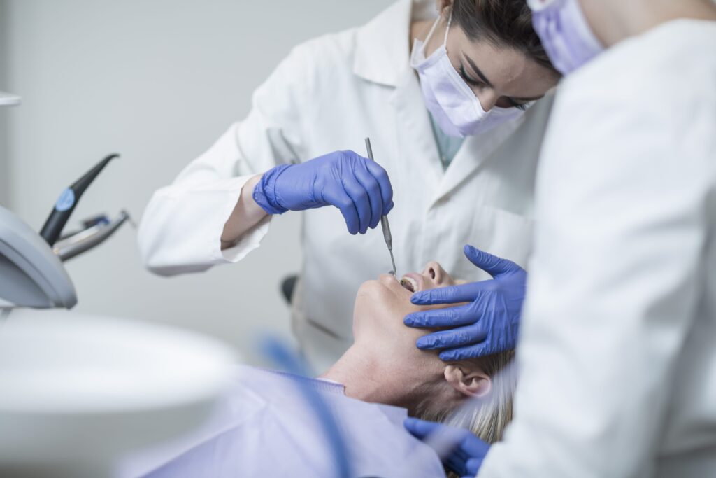 Female dentist examining patient.