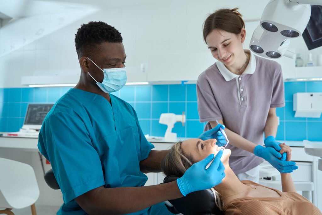 examining patient teeth in the clinic