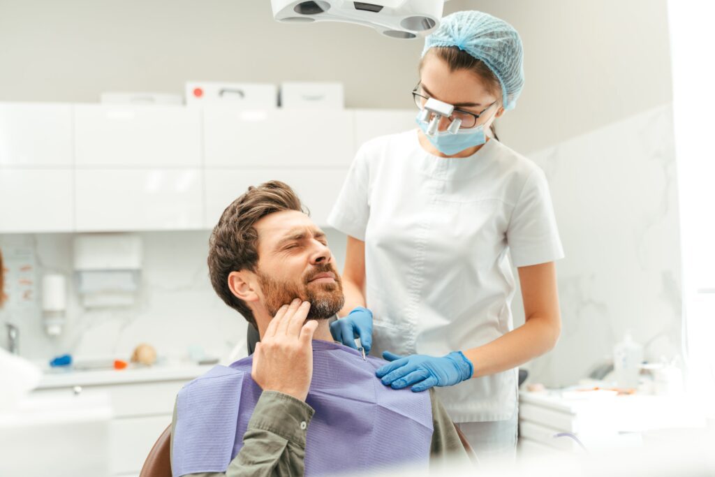 Portrait of male patient sitting in dental chair.