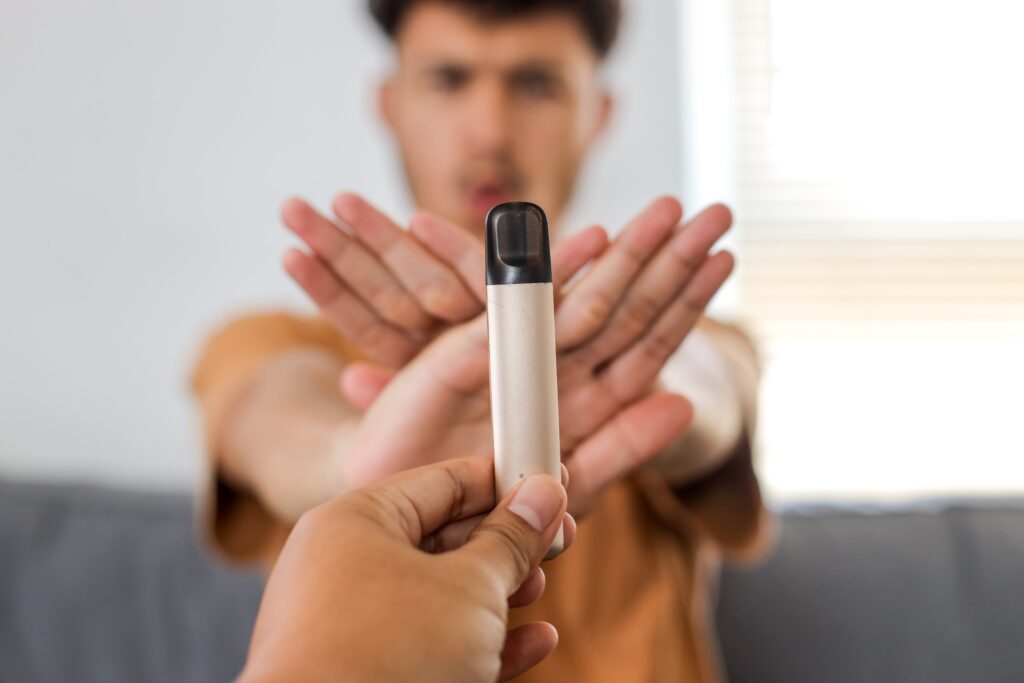 Young boy refuses disposable cigarette. No smoking concept.