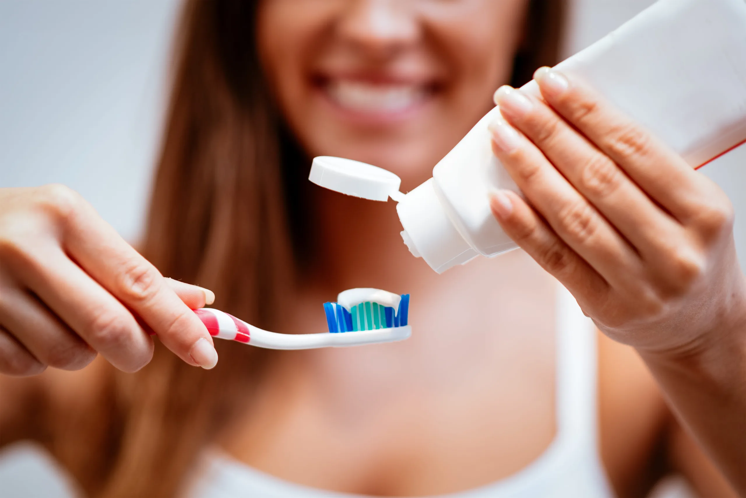 Woman Applying Toothpaste To Brush, Dental Hygiene